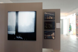 Exhibition overview of Ode To The Bijlmer at CBK Zuidoost, Zoekende collab Koster project Bijlmer Years 1989-1997, pinhole photography on light box, video stills